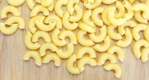 Macaroni Noodles spilt on a wooden floor